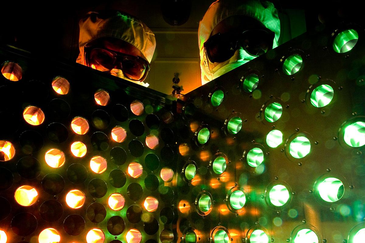 Two researches at the University of Rochester pose infront of an eform mirror.